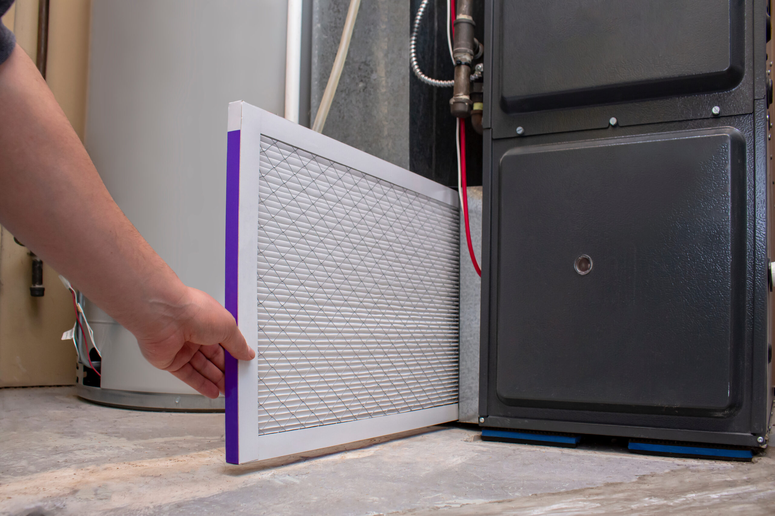 A person changing an clean air filter